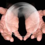 hands around a large floating bubble