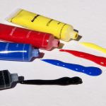 tubes of yellow, red, blue, black paint