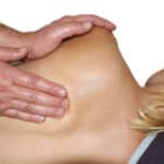 person massaging fascia of a client